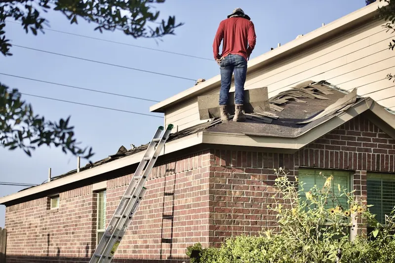 Professional roofer working on a residential roof in Washington Corner